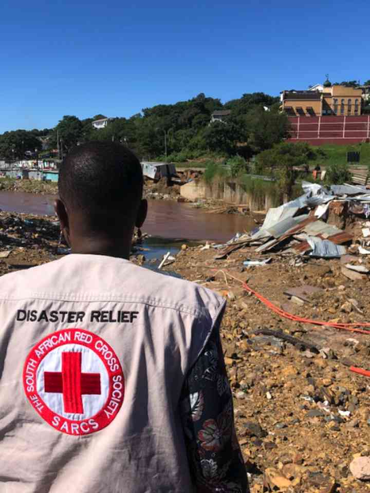 Disaster relief worker by a flood impacted urban area
